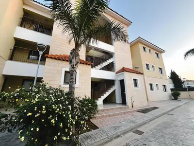 a building with a palm tree in front of it at Déjà Blue Apartment Kyklades BC7 - workspace, pool, gym, nearby beach in Protaras