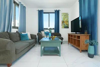 a living room with a couch and a tv at Villa Jasmin - 4Bed with Private Pool in Paralimni