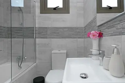 a bathroom with a sink and a toilet and a shower at Villa Jasmin - 4Bed with Private Pool in Paralimni