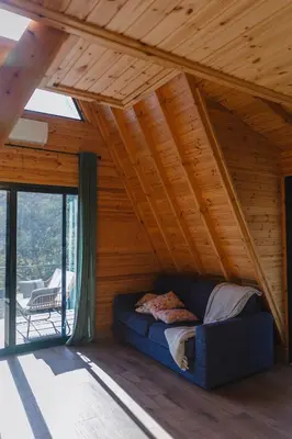 a bed in a room with a wooden ceiling at Private Glamping Cabin for Family Getaway with BBQ in Arakapas