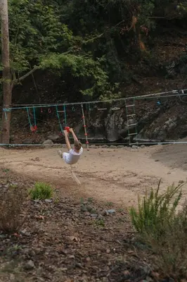 a person is jumping in the air on a playground at Private Glamping Cabin for Family Getaway with BBQ in Arakapas