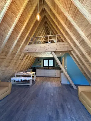 a large room with a loft with wooden ceilings at Private Glamping Cabin for Family Getaway with BBQ in Arakapas