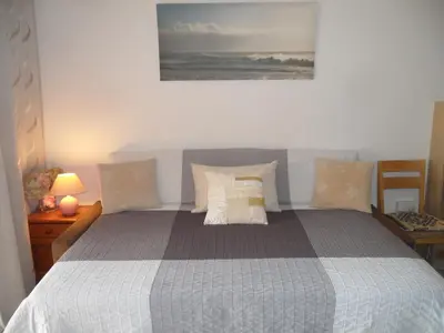 a bedroom with a bed with pillows and a picture on the wall at Nissi Area,Ground Floor Flat, Free internet in Ayia Napa