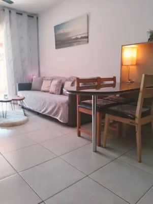 a living room with a table and a couch at Nissi Area,Ground Floor Flat, Free internet in Ayia Napa