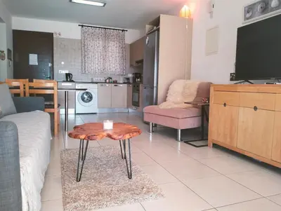a living room with a couch and a table at Nissi Area,Ground Floor Flat, Free internet in Ayia Napa
