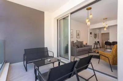 a living room with black chairs and a couch at City Hall Suites in Limassol