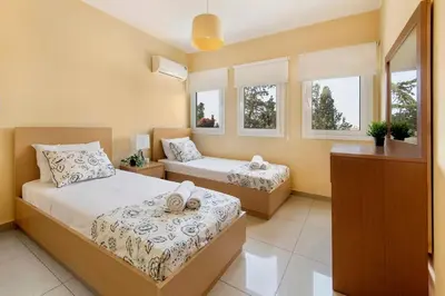 a bedroom with two beds and two windows at City Center, Nice View, 2BR in Larnaka