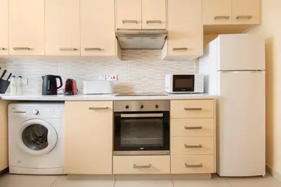 a kitchen with a refrigerator and a washing machine at City Center, Nice View, 2BR in Larnaka
