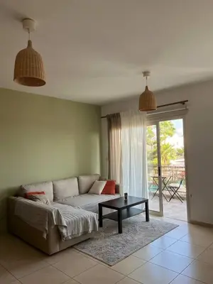 a living room with a couch and a table at Limassol Star Complex Seaview Apartment in Limassol