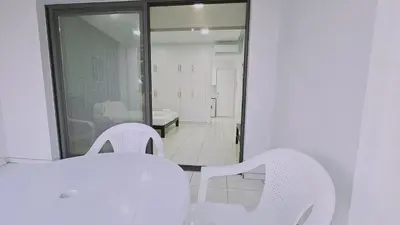 a white table and chairs in a room with a mirror at STAY Cypress Studio in Limassol