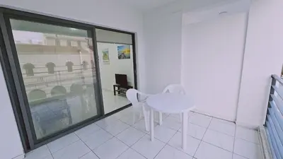 a white table and chairs in a room with a window at STAY Cypress Studio in Limassol