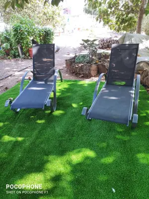 two chairs sitting on the grass in a yard at Little Paradise in Sotira