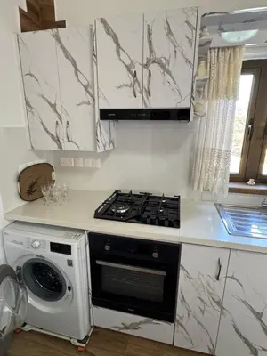 a kitchen with a stove top oven next to a dishwasher at Little Paradise in Sotira