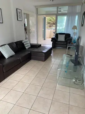 a living room with a couch and a glass table at Atlantis Court in Makenzy in Larnaka