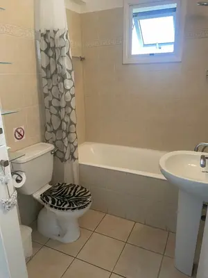 a bathroom with a toilet and a sink at Atlantis Court in Makenzy in Larnaka