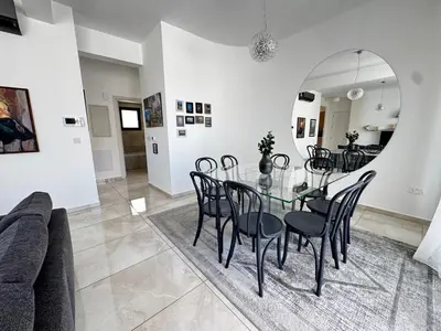 a dining room with a glass table and chairs at Wealthystays Premium Residence in Nicosia