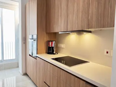 a kitchen with wooden cabinets and a sink at Wealthystays Premium Residence in Nicosia