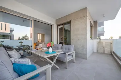 a living room with a couch and a table at Mulberry Court Premium Apartments in Limassol