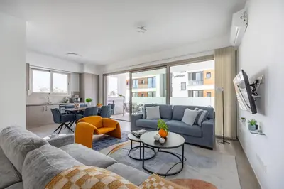 a living room with a couch and a table at Mulberry Court Premium Apartments in Limassol