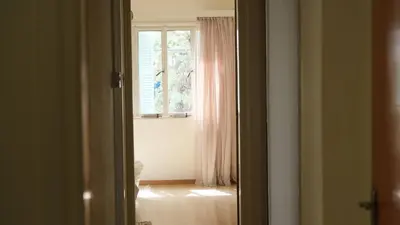 an open door to a room with a window at Gladstone Apartment by Tangerine in Nicosia
