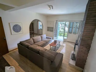 a living room with a couch and a table at Gladstone Apartment by Tangerine in Nicosia