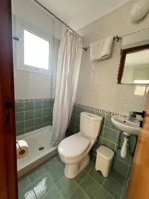 a bathroom with a toilet and a sink at Trinity Blue Apt in Paralimni