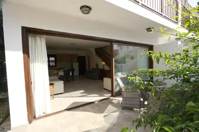 a sliding glass door leading into a living room at The Bay Villa in Pissouri