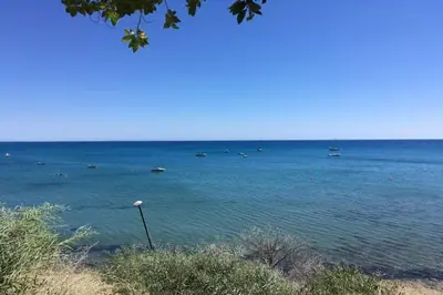 a large body of water with boats in it at The Bay Villa in Pissouri