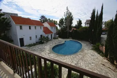 a swimming pool in front of a house at The Bay Villa in Pissouri