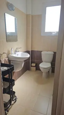 a bathroom with a white toilet and a sink at Obv 3206 in Pyla