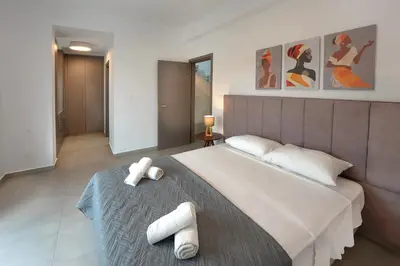 a bedroom with a large bed with two towels on it at Sun and Moon Luxury Villas Ayia Napa in Ayia Napa