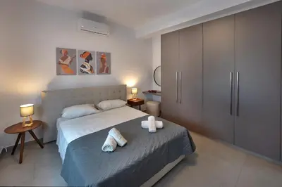 a bedroom with a bed with towels on it at Sun and Moon Luxury Villas Ayia Napa in Ayia Napa