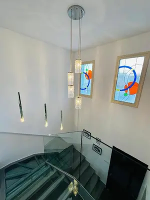 an escalator in a building with stained glass windows at Villa Eva in Mazotos