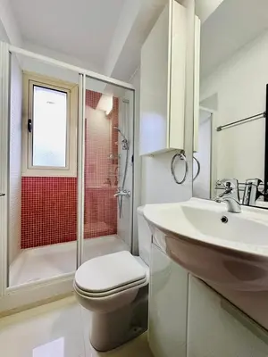 a bathroom with a toilet and a sink and a shower at Villa Eva in Mazotos