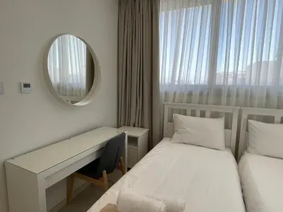 a small room with a bed and a mirror at City Napa Seaview Villas - Villa 2 in Ayia Napa