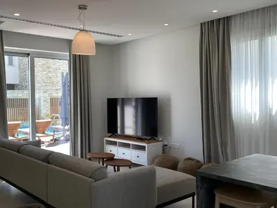 a living room with a couch and a flat screen tv at City Napa Seaview Villas - Villa 2 in Ayia Napa