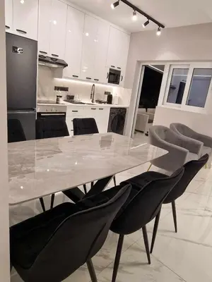 a dining table and chairs in a kitchen at 3 rooms modern apartment close to the beach! in Larnaka