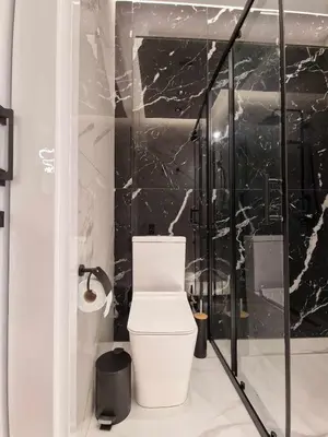 a bathroom with a toilet and a glass shower at 3 rooms modern apartment close to the beach! in Larnaka