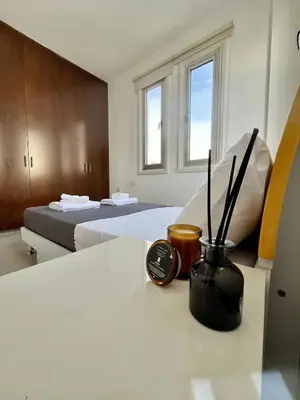 a room with two beds and a clock on a table at Luxury Villa Azure in Larnaka
