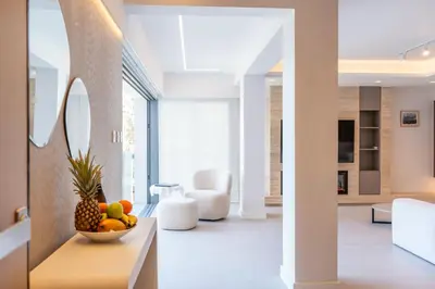 a living room with a bowl of fruit on a table at Deluxe Seafront - 2 Bed in Limassol