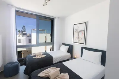two beds in a room with a window at Protaras Aqua Pearl Villa AQ18 in Protaras