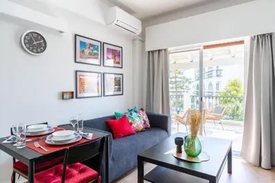 a living room with a couch and a table at Lazy River 1-Bedroom Apartment in Larnaka