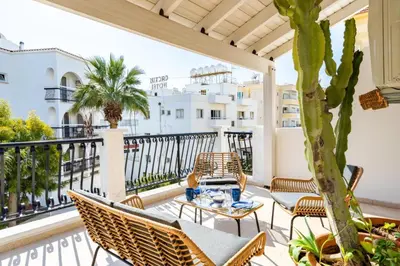 a patio with chairs and a table on a balcony at Lazy River 1-Bedroom Apartment in Larnaka