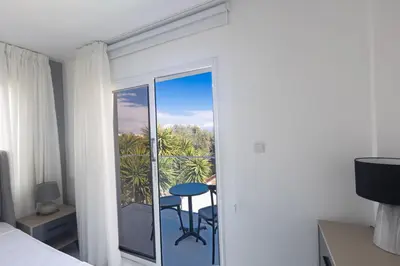 a room with a bed and a balcony with a table at Mandali Villa 20 - Fully Renovated Villa in Paralimni