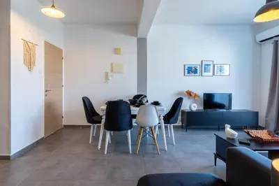 a dining room with a table and chairs at Snobby 2-Bedroom Apartment in Larnaka