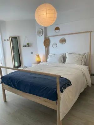 a bedroom with a large bed with a blue blanket at Seaview City Retreat in Larnaka