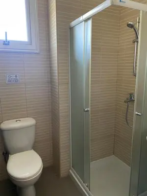 a bathroom with a toilet and a glass shower at Apartment Lorena Protaras in Protaras