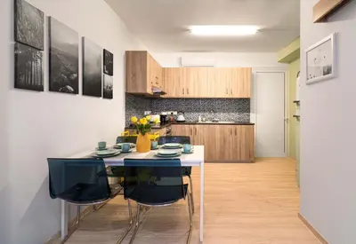 a kitchen with a table and some chairs at Beach Walk - Central, Cool, Cute, Convenient in Limassol