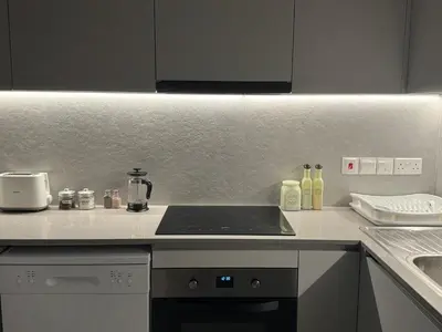 a kitchen with a stove top oven next to a sink at Brandnew Rooftop Flat near Larnaca Mall in Larnaka