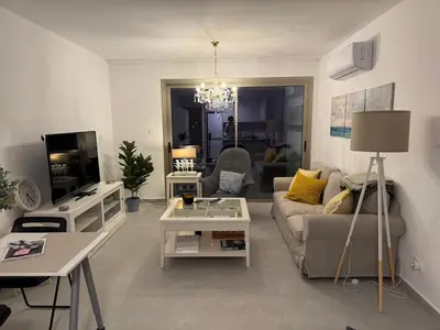 a living room with a couch and a tv at Brandnew Rooftop Flat near Larnaca Mall in Larnaka